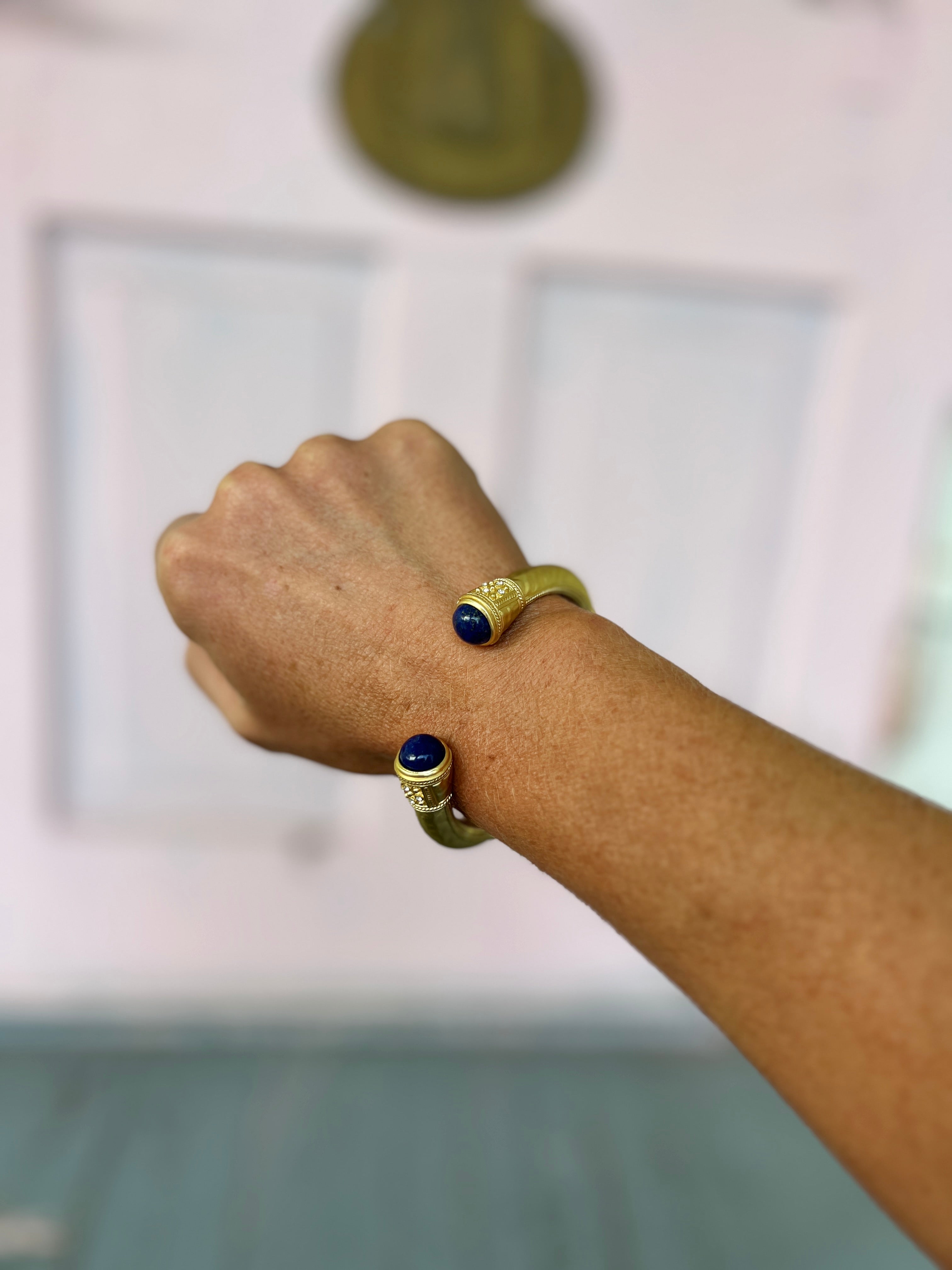 Hammered metal cuff bracelet with dark blue stone end caps