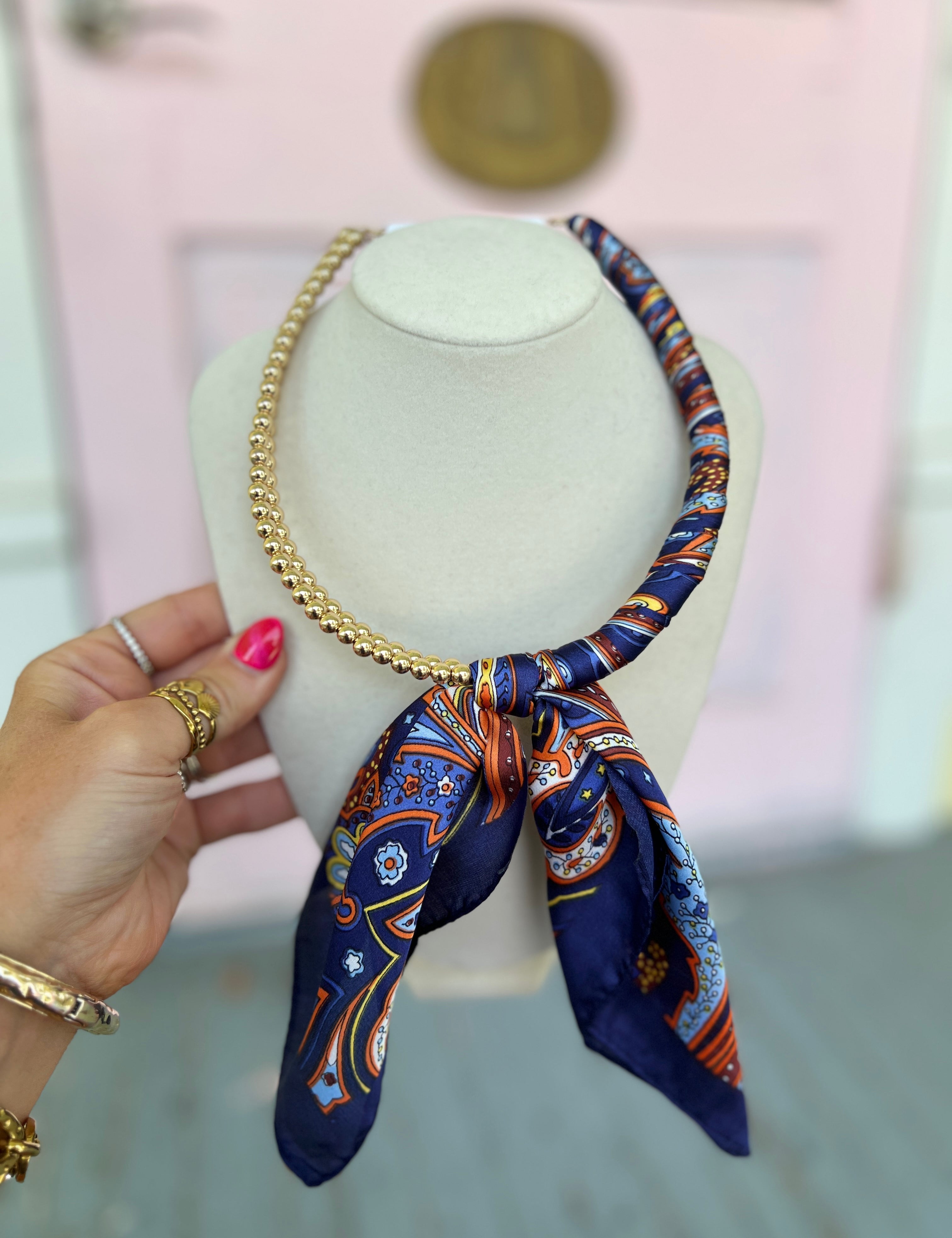 Blue patterned scarf necklace with gold chain and tied bow detail