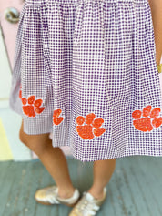 Purple check seersucker skirt with orange paw-print graphics
