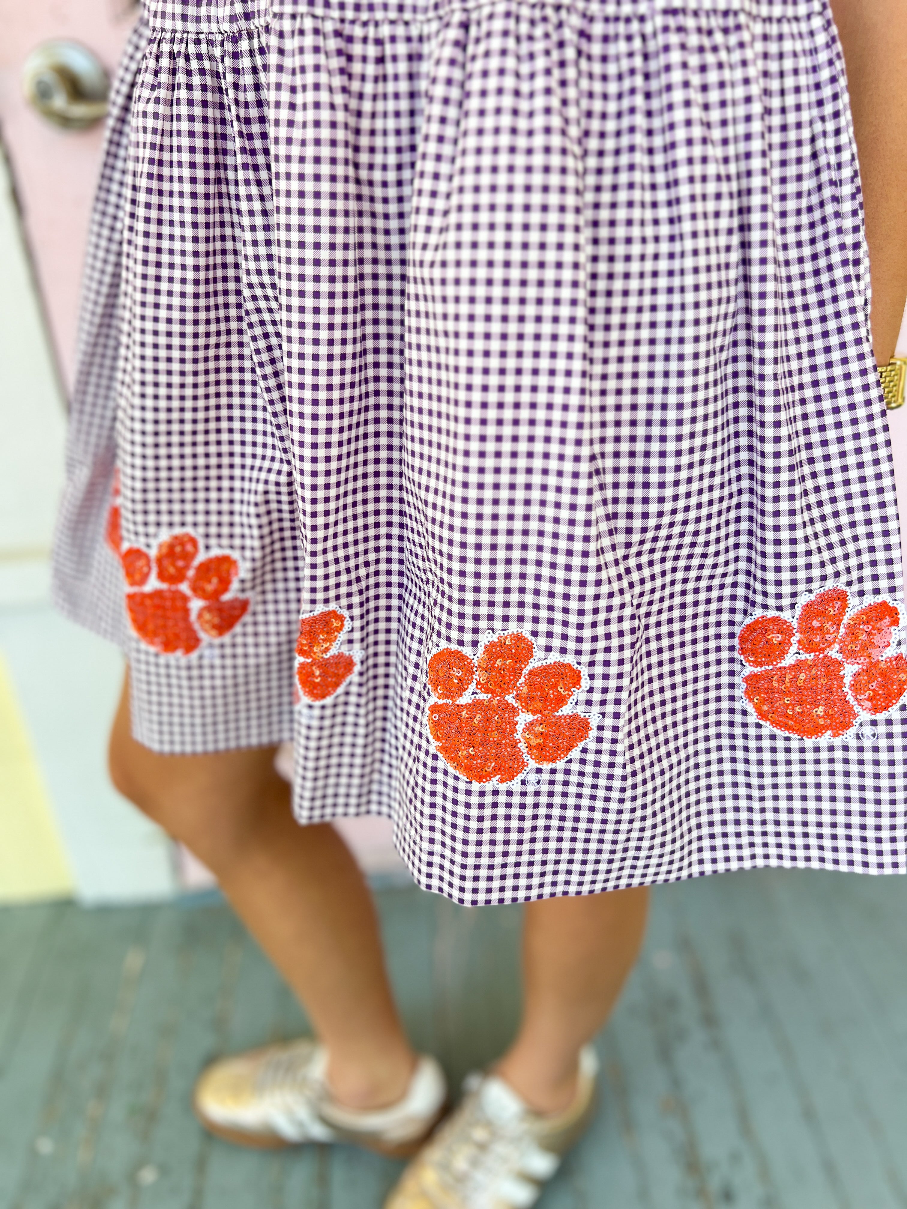 Purple check seersucker skirt with orange paw-print graphics