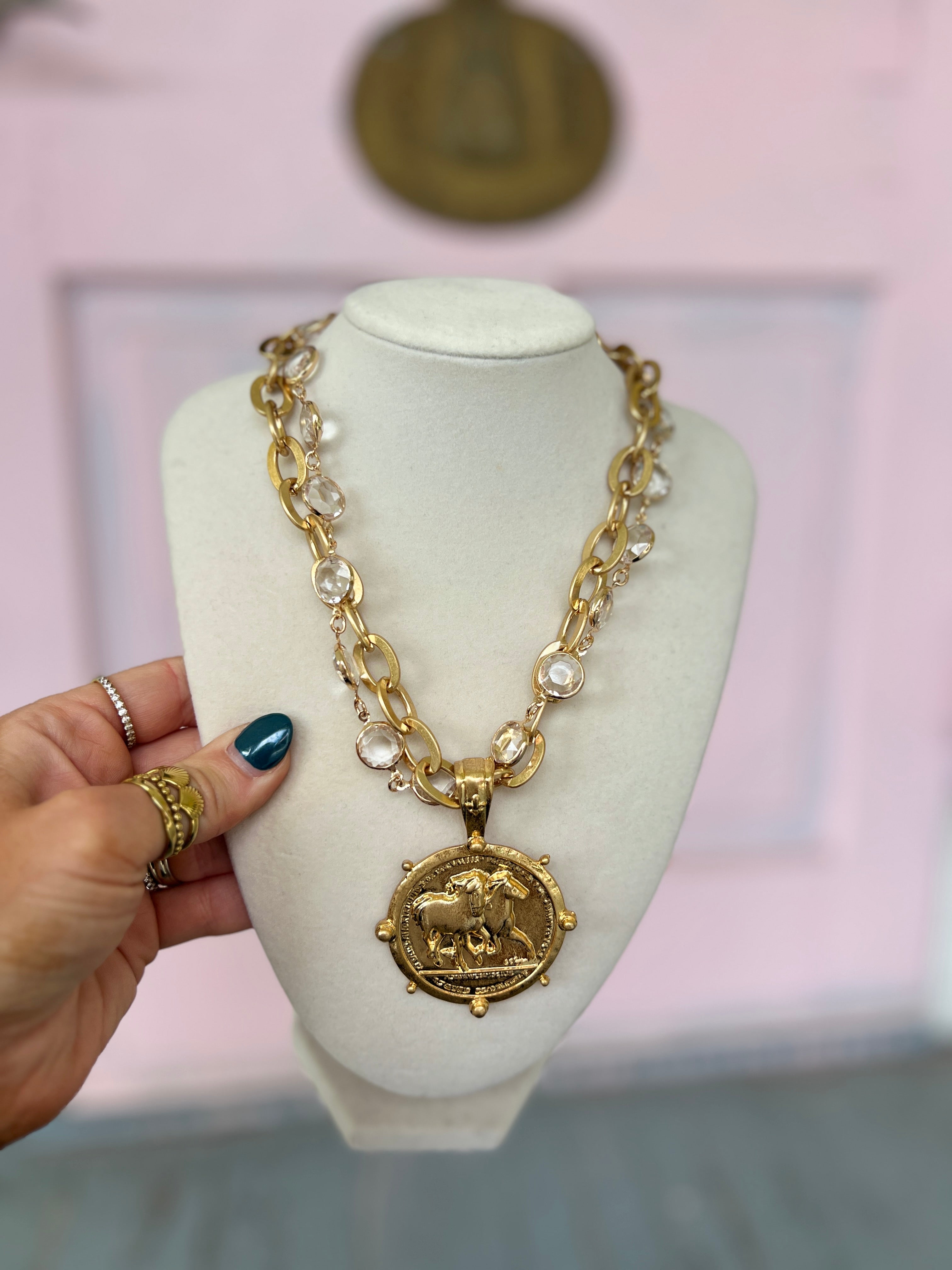 Goldtone layered chain necklace with medallion pendant