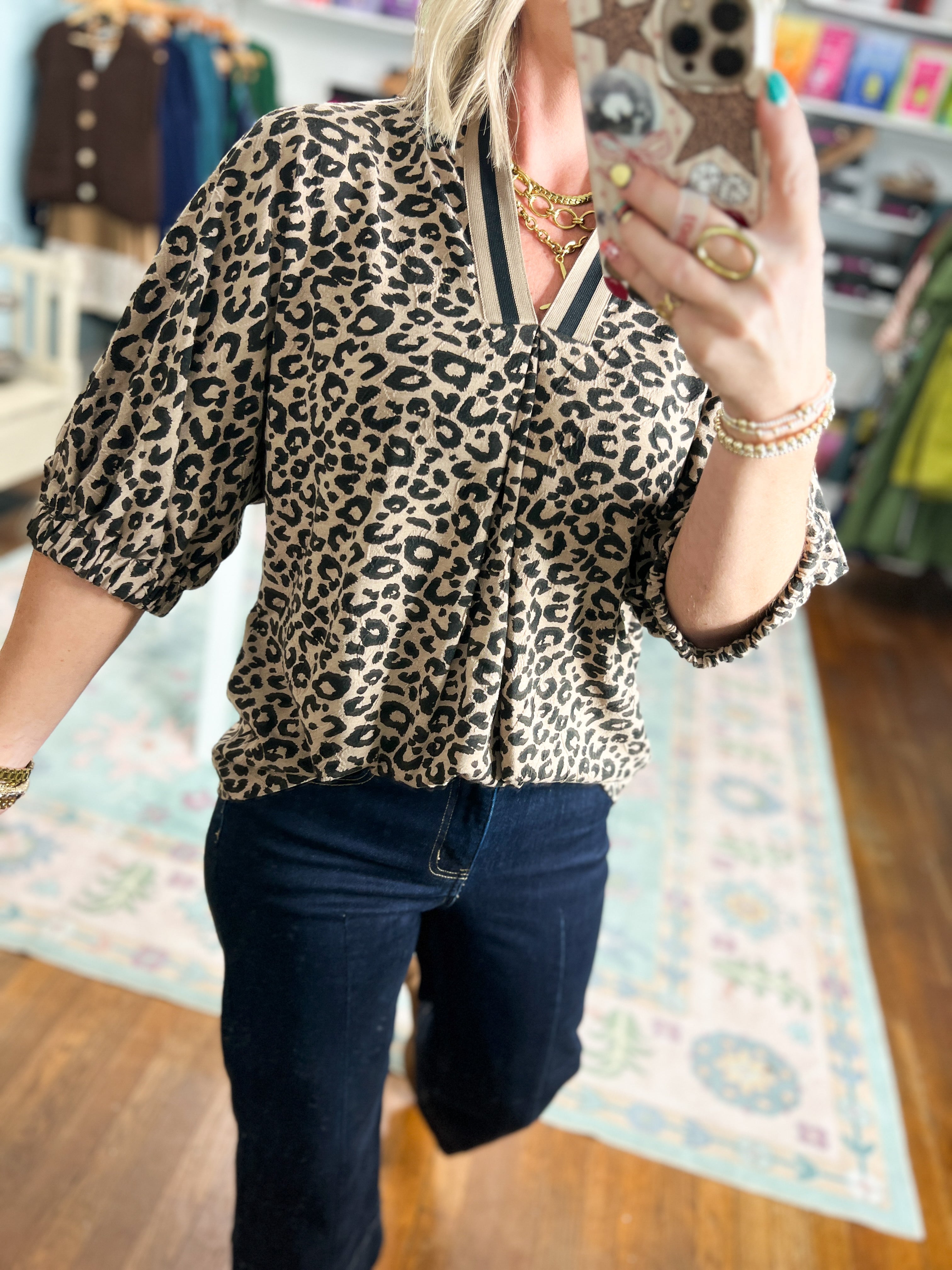 Leopard print pleated blouse top with V-neck, three-quarter pleated sleeves