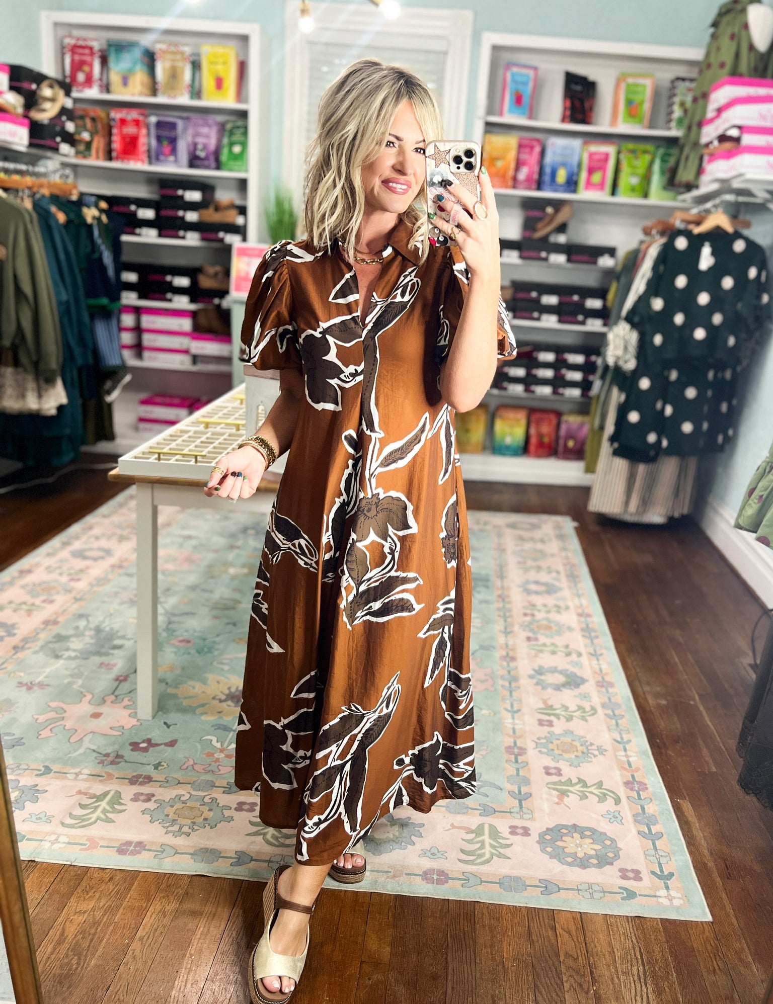 Rust-brown puff sleeve maxi dress with abstract black-and-white floral print, three-quarter view