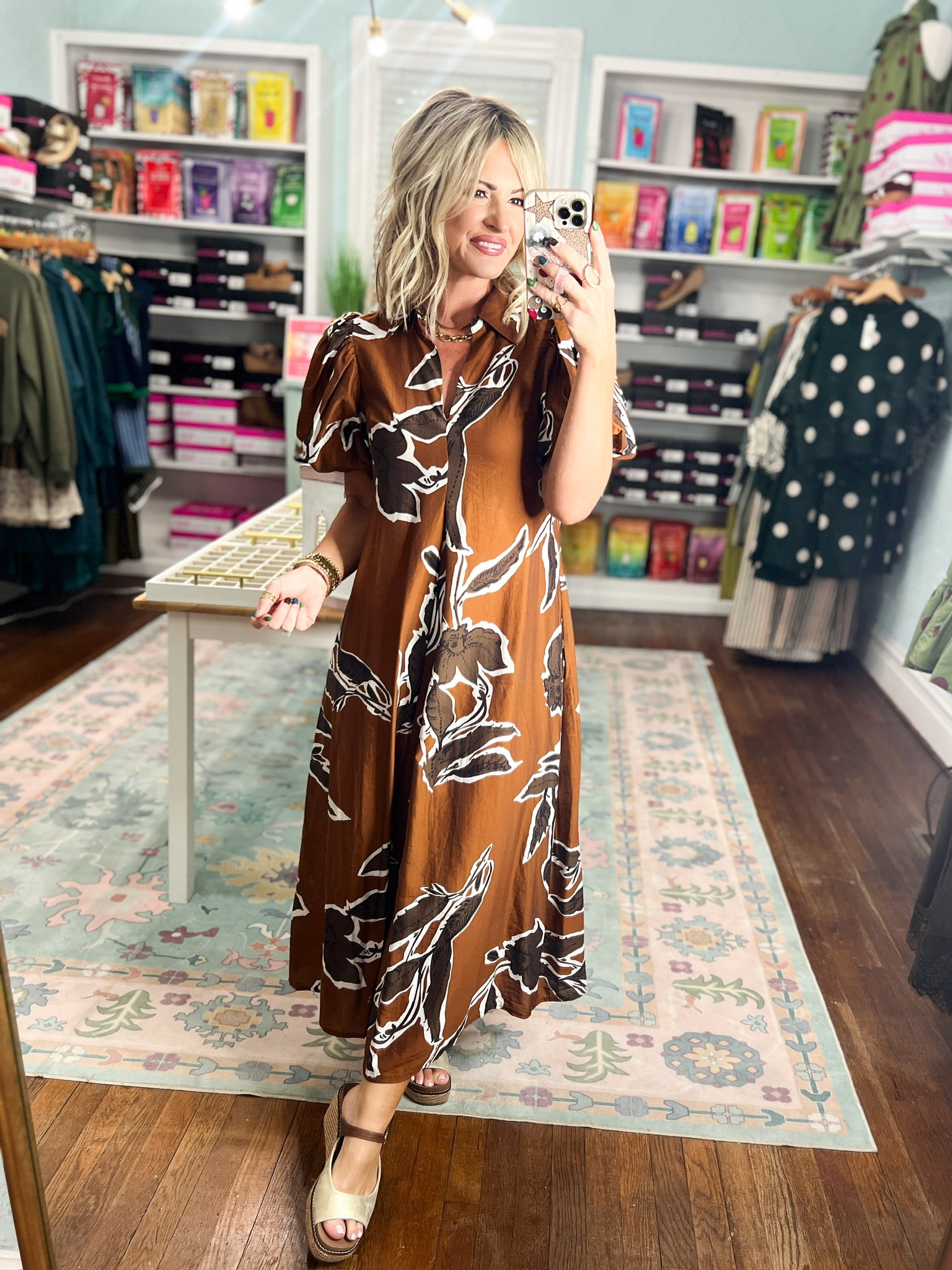 Rust-brown puff sleeve maxi dress with abstract black-and-white floral print, three-quarter view