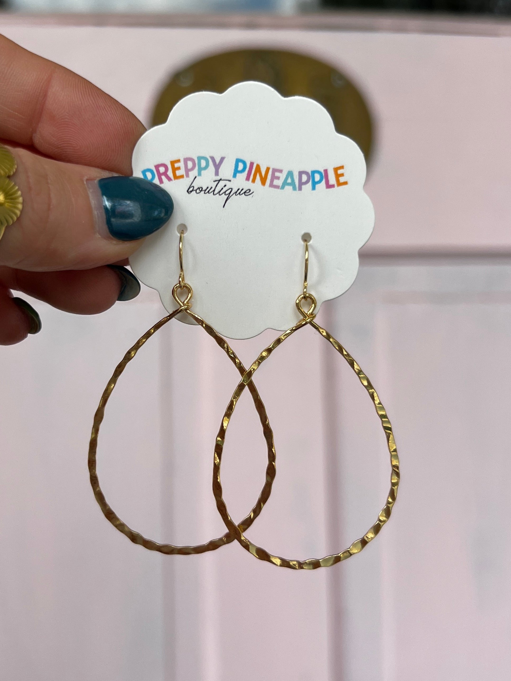 Gold textured teardrop drop earrings with hinged hooks, cross-dangle style