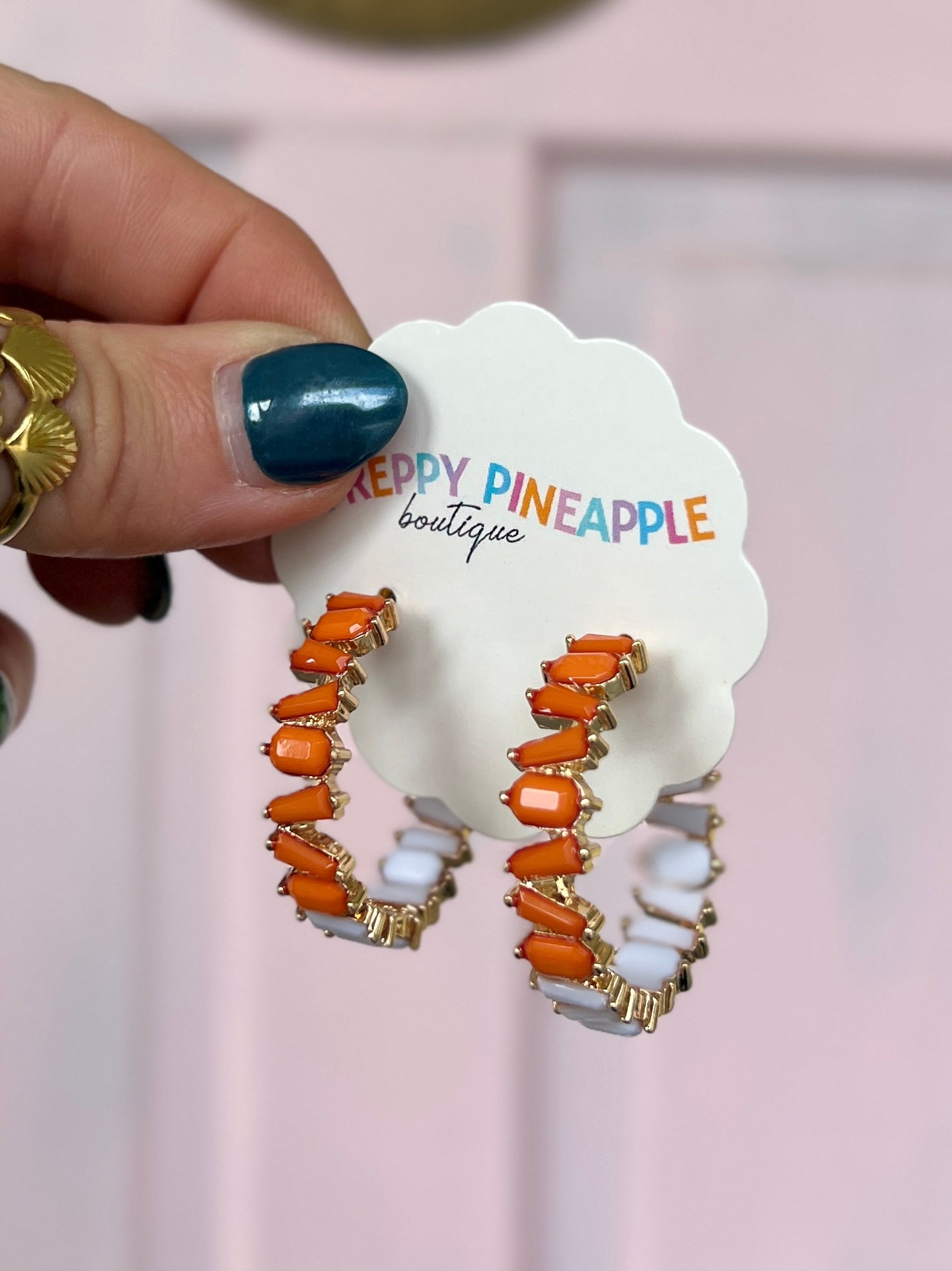Orange acetate bead hoop earrings with gold-tone accents and hinged backs