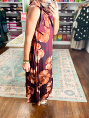 Sleeveless midi dress with burgundy floral print and tied bow neckline