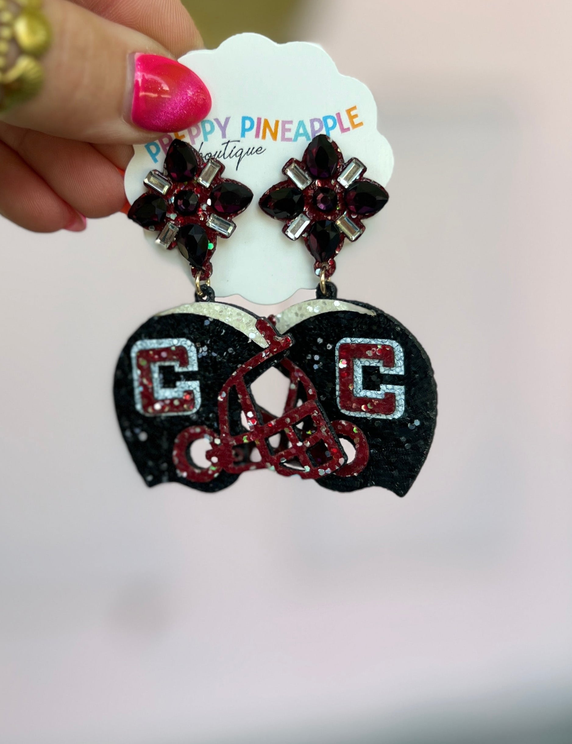 Glitter black helmet-shaped drop earrings with red bead accents and crystal studs