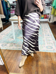 Brown zebra-print midi pencil skirt with white zebra stripe pattern and fitted cut
