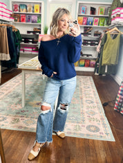 Navy off-shoulder sweater with long sleeves and relaxed silhouette
