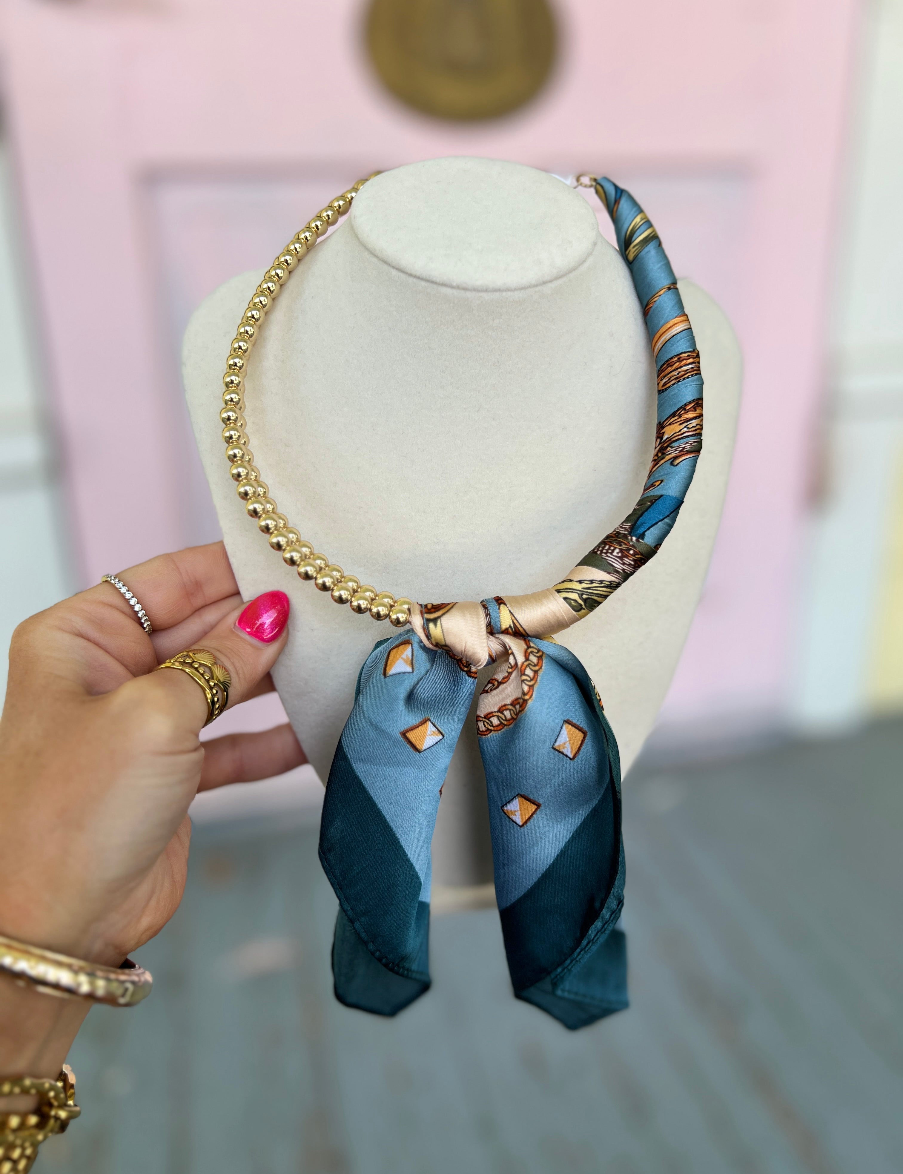 Navy ball scarf necklace with gold chain and blue patterned scarf pendant