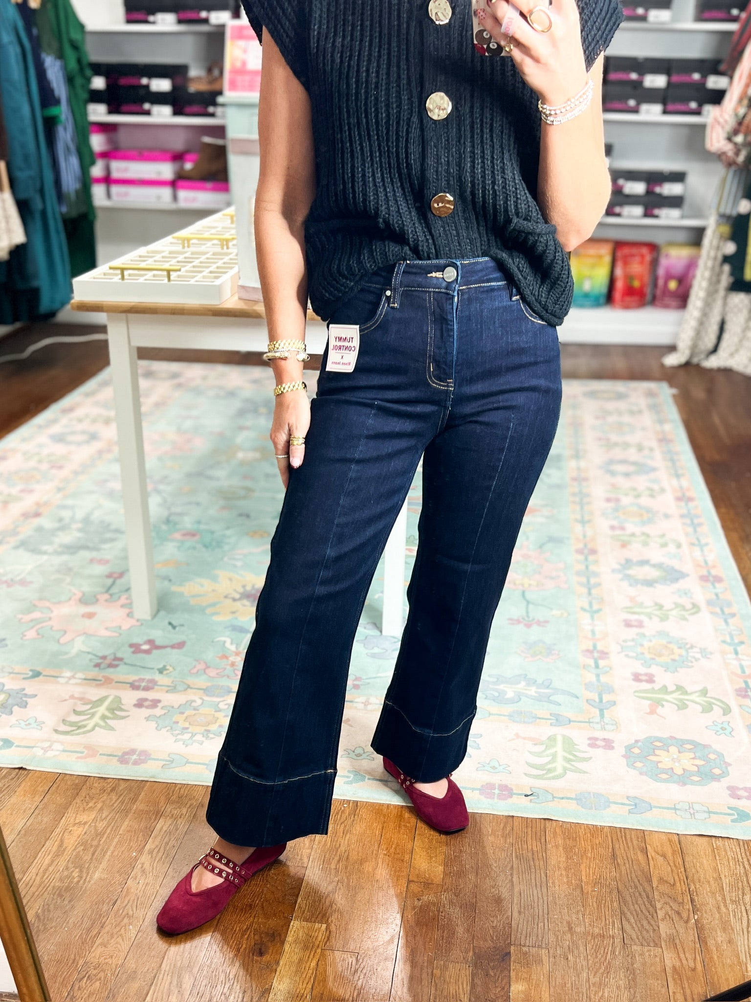 Dark high-rise wide-leg jeans with button closure and slanted front pockets