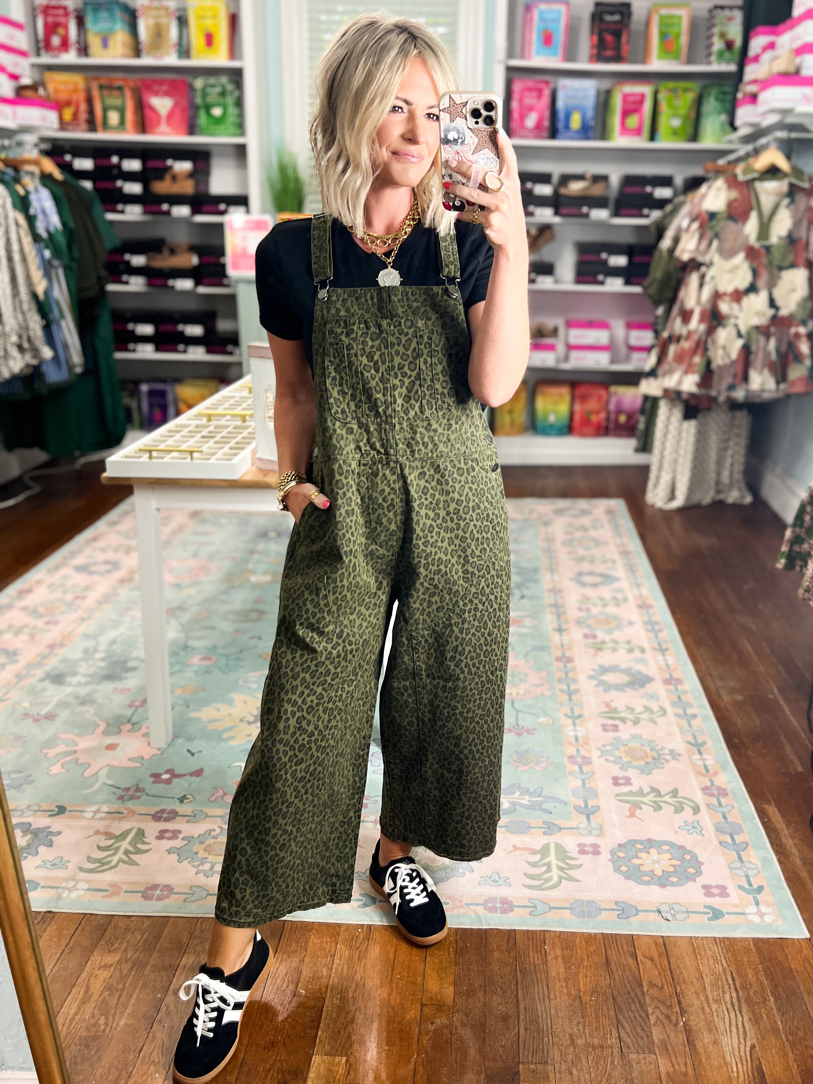 Olive patterned twill overalls with bib front, wide legs, and shoulder straps