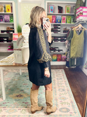 Black dress with gold leopard-spot embroidery along sleeves and front