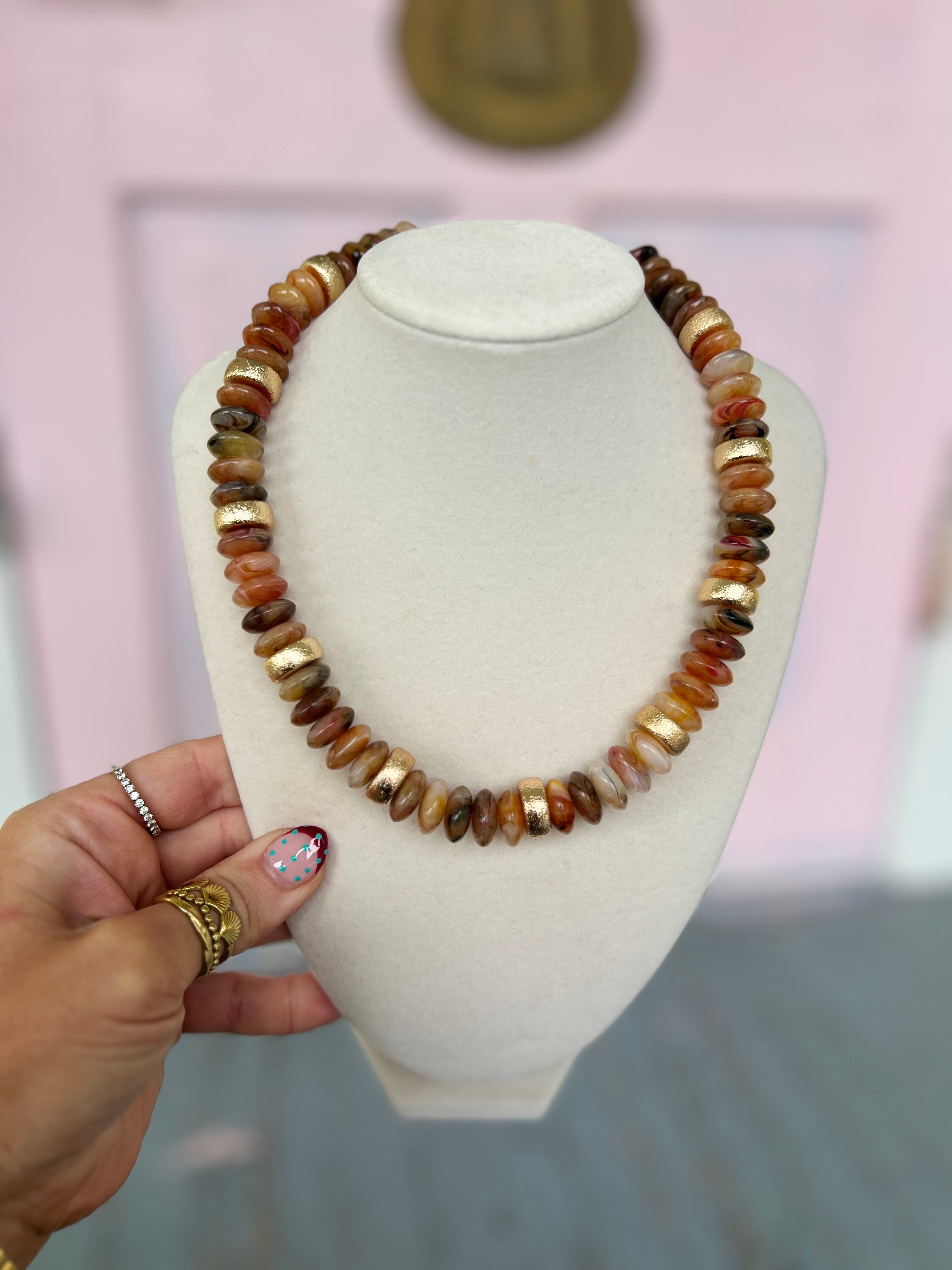 Brown and gold-tone bead necklace with rounded rondelles and gold caps