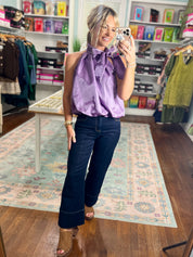 Purple sleeveless balloon top with ruffled high neckline and gathered front