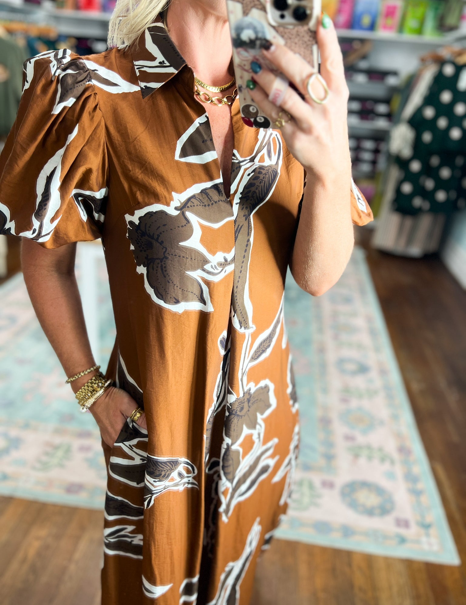 Rust-brown puff sleeve dress with abstract black and white floral print