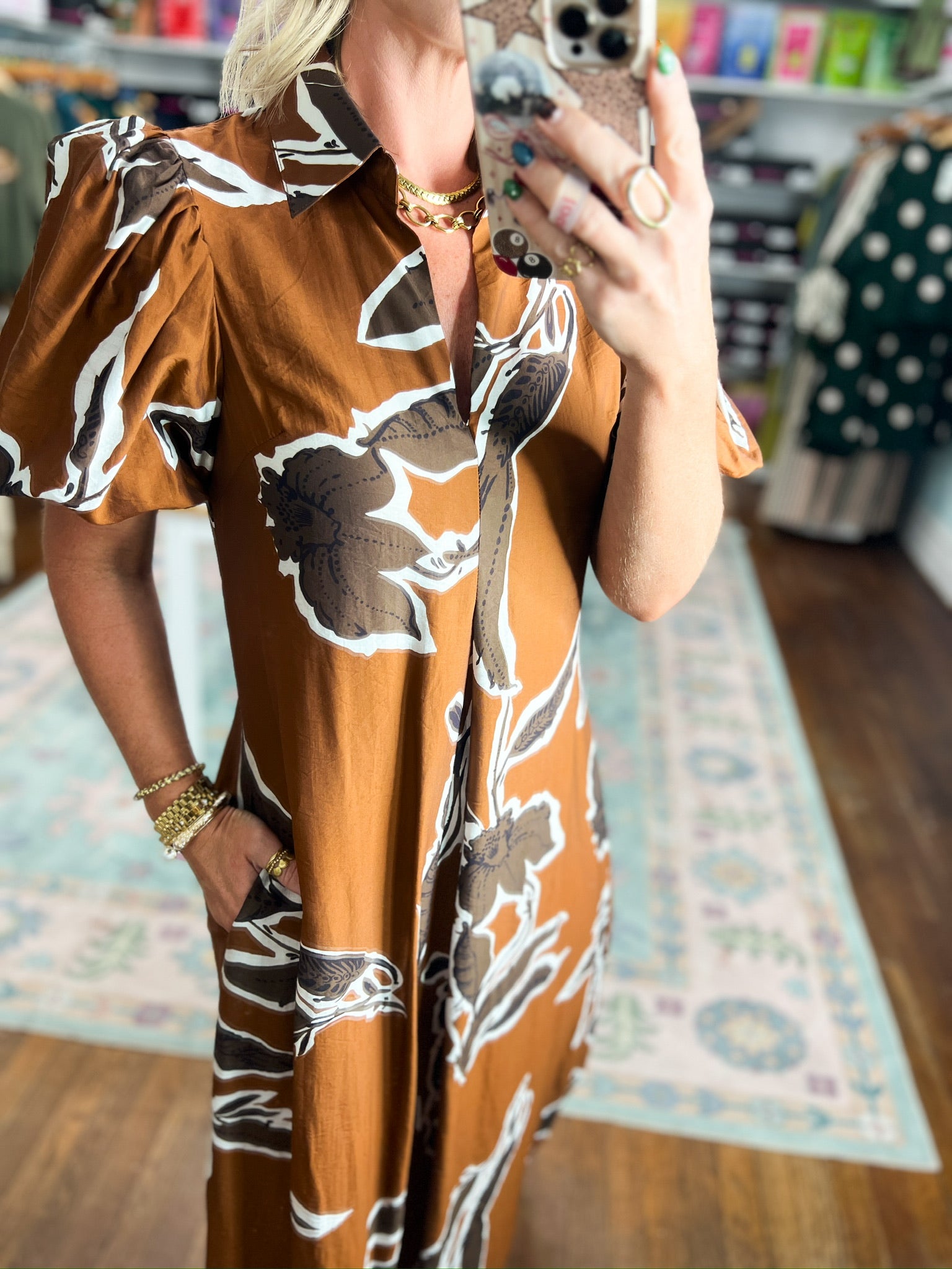 Rust-brown puff sleeve dress with abstract black and white floral print