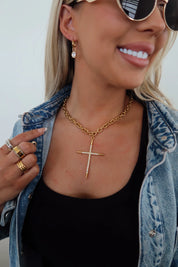 Gold cross pendant necklace on a fine chain