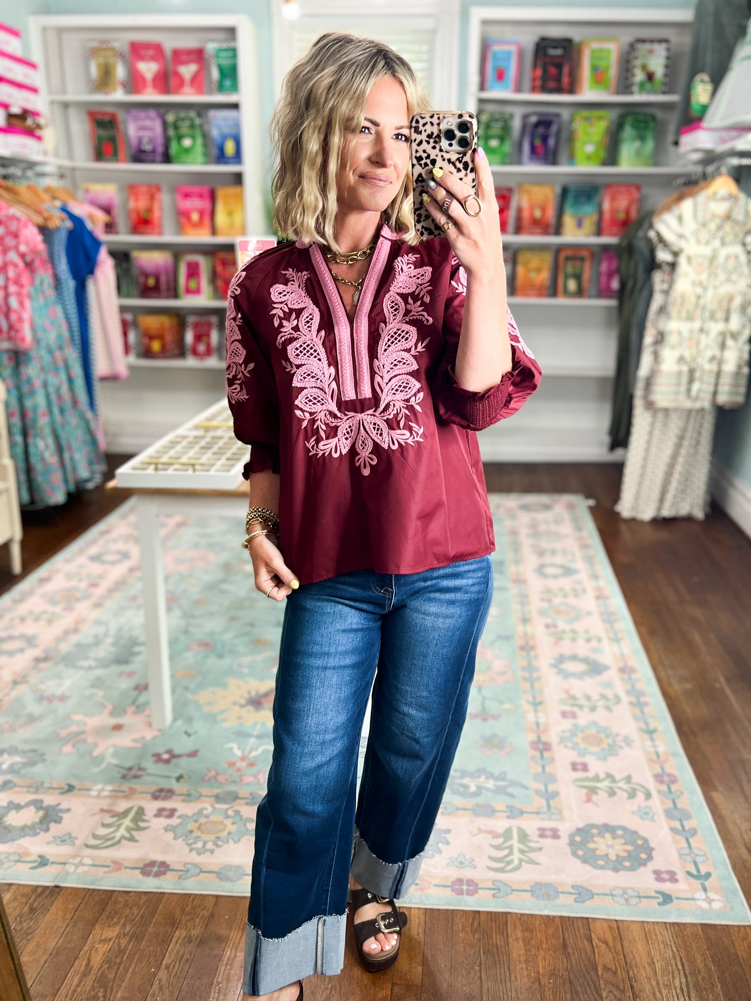Burgundy embroidered peasant-style blouse with long sleeves and front lace-up detail