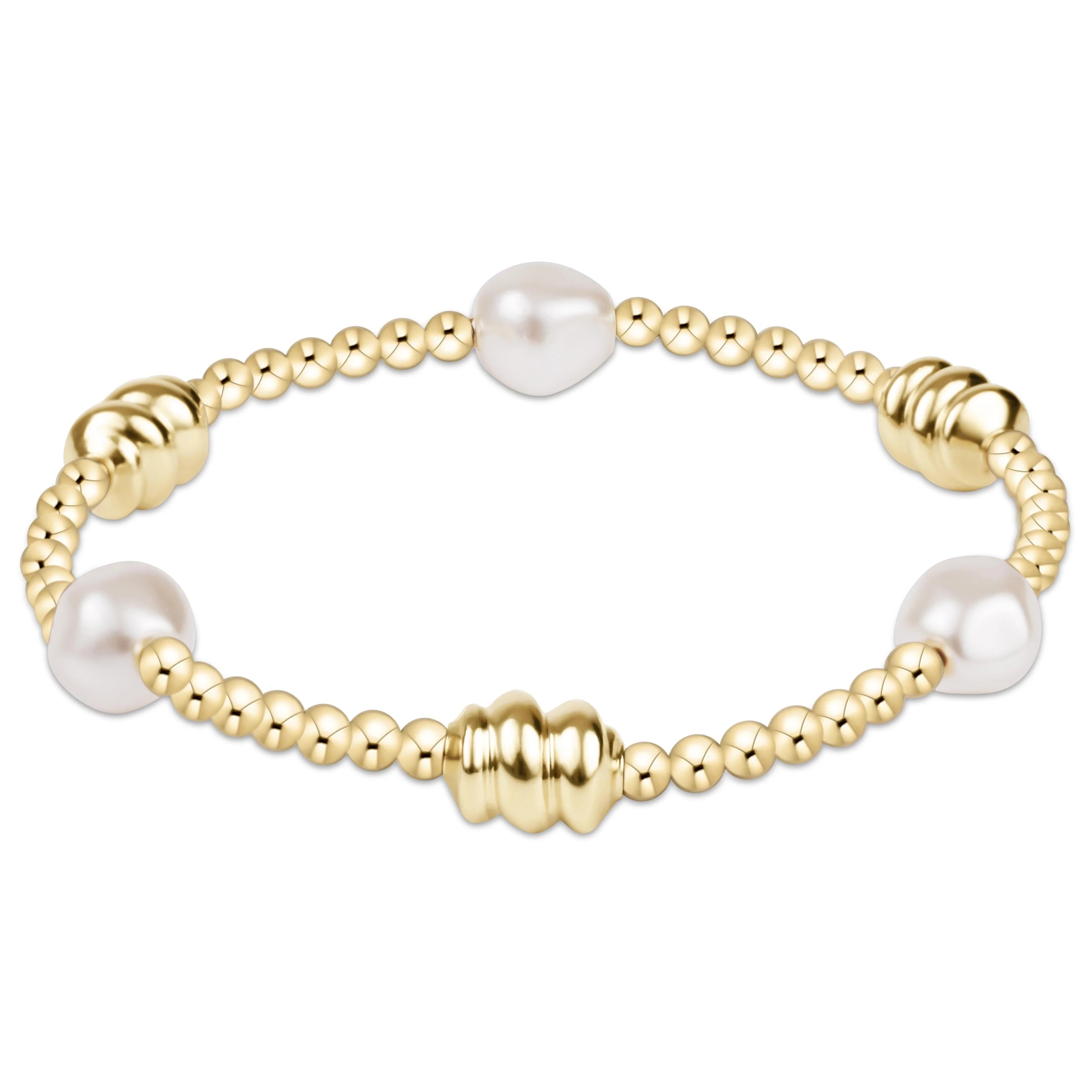 Gold bead bracelet with white pearl accents and ribbed center bead