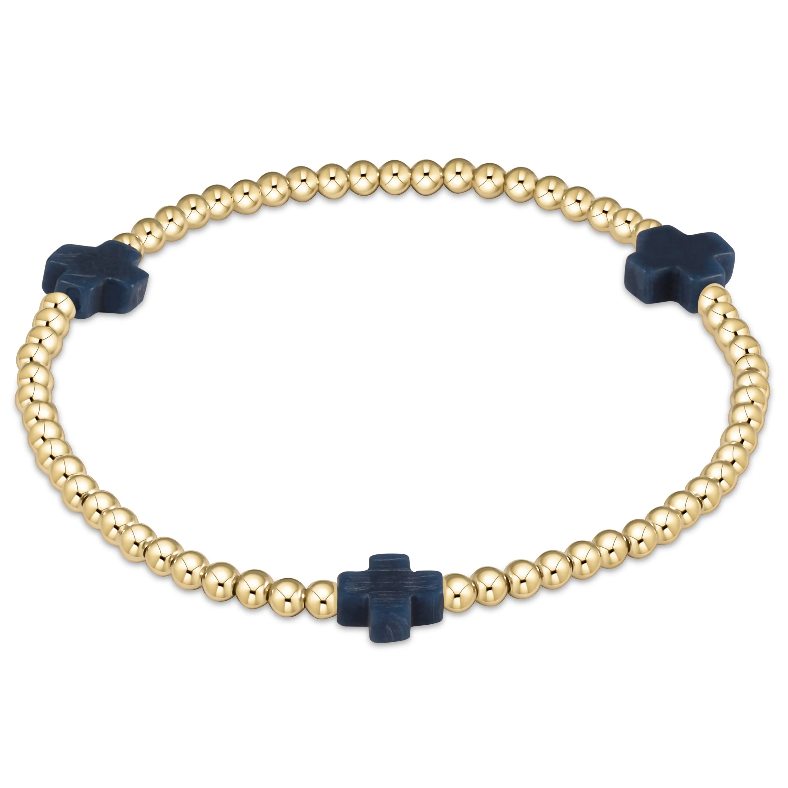 Gold beaded bracelet with navy cross center charm