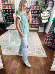 Hunter green and white striped short-sleeve crew-neck top, side view