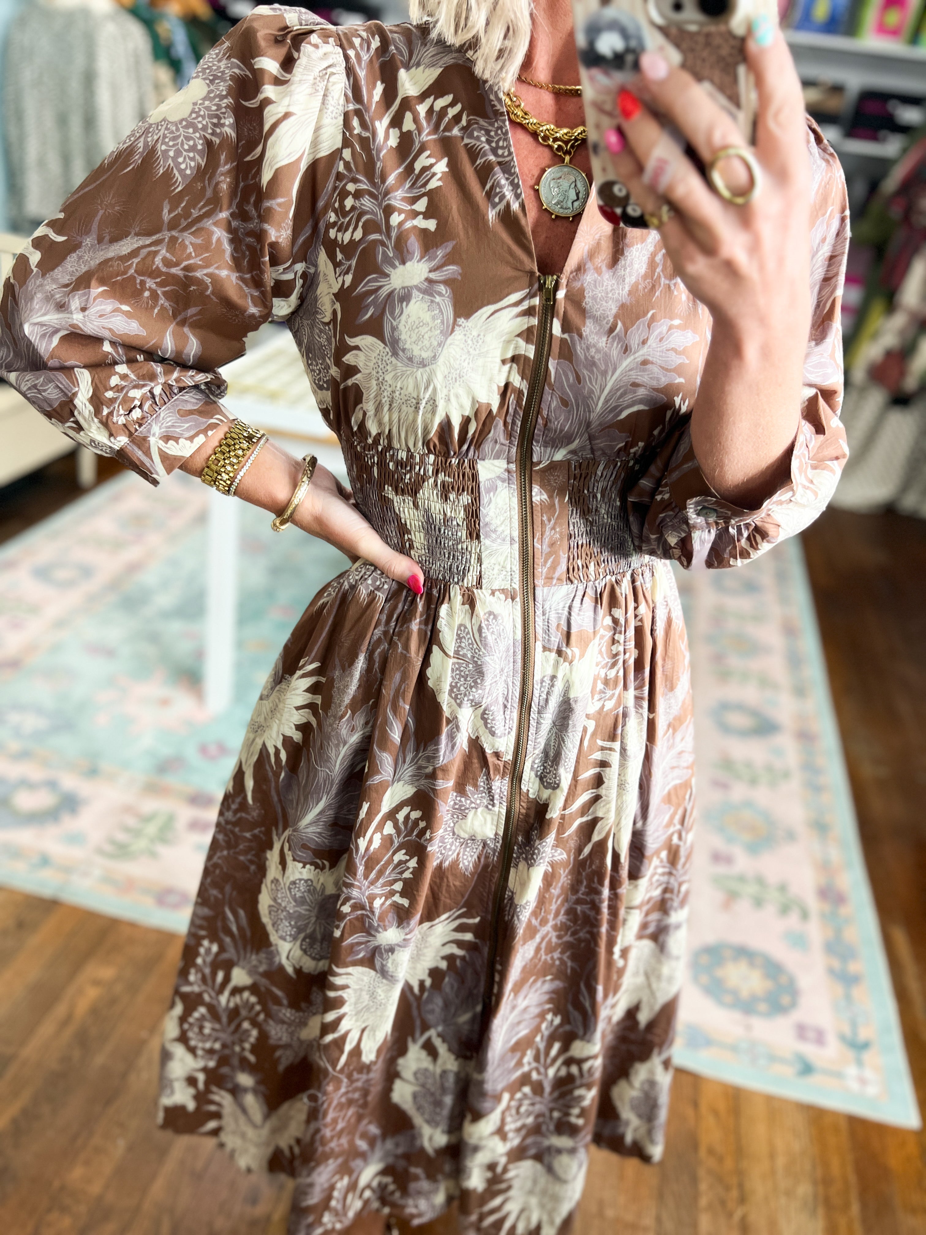Close-up of mocha botanical midi dress with front buttons and long puff sleeves