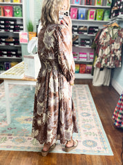 Mocha botanical print midi dress viewed from the side with long sleeves
