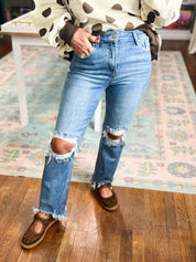 High-rise crop straight jeans in medium wash, distressed knee rips and frayed cuffs