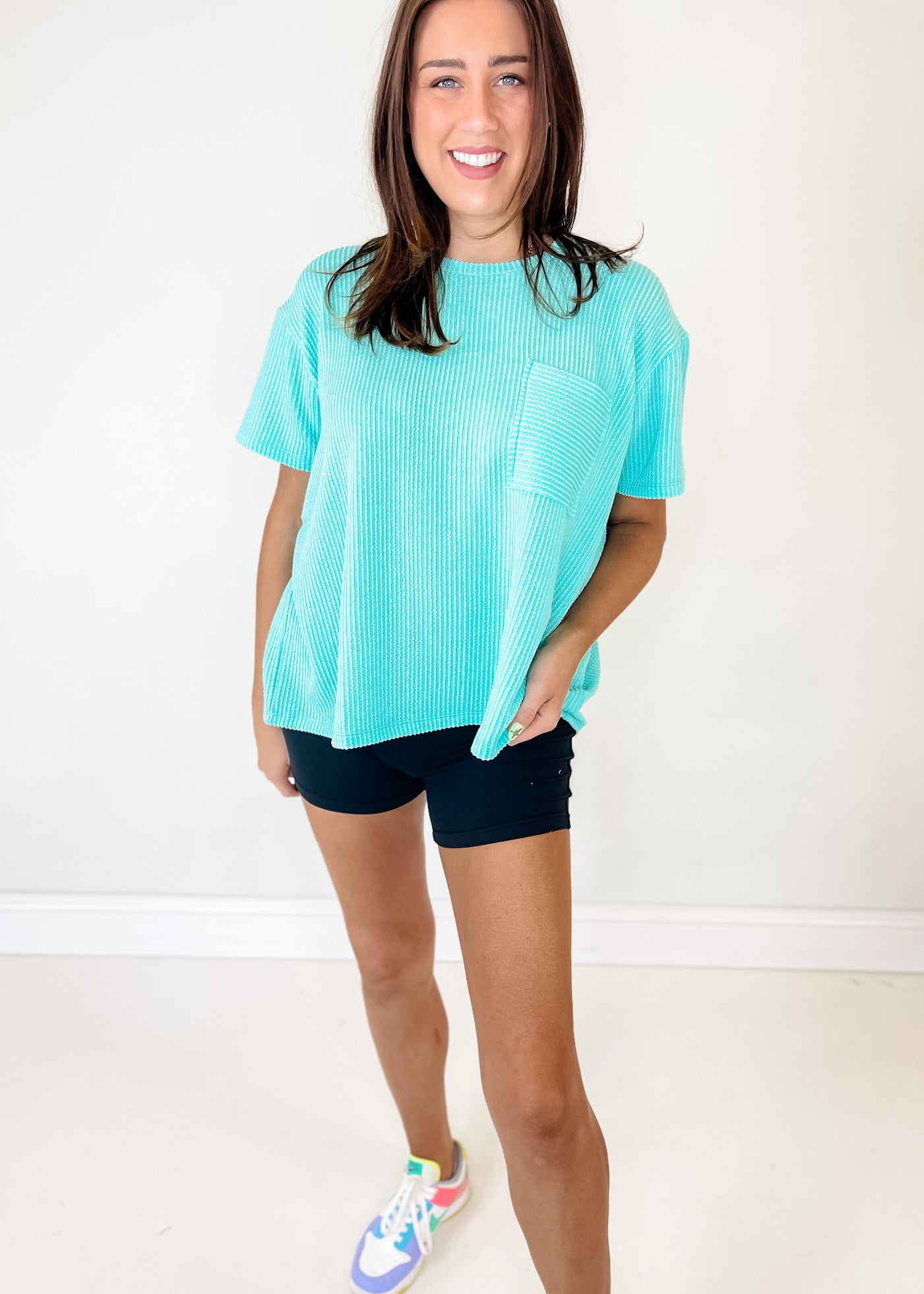 Black biker shorts, fitted mid-thigh length with smooth waistband.