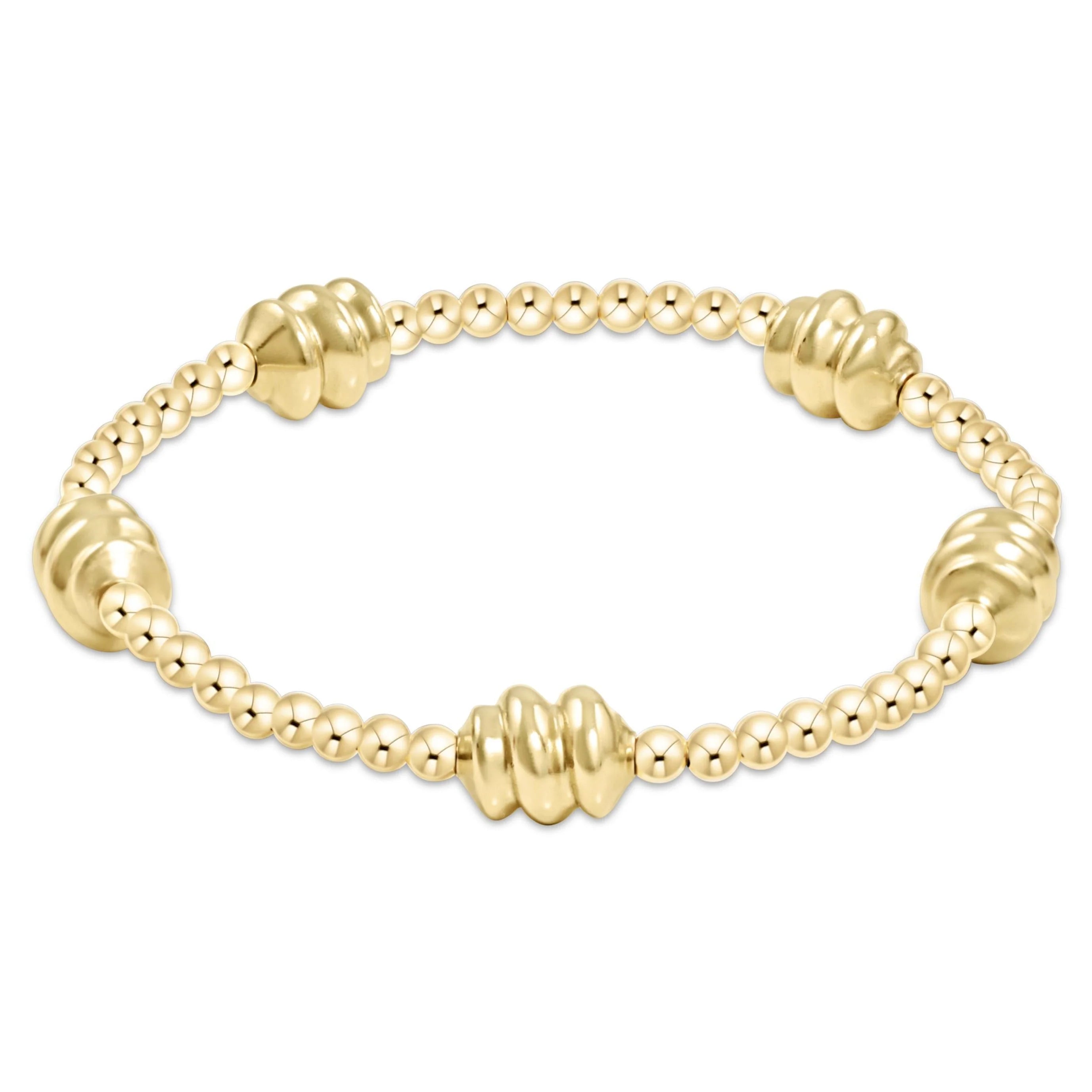 Gold-tone beaded bracelet with ribbed barrel links and smooth round beads