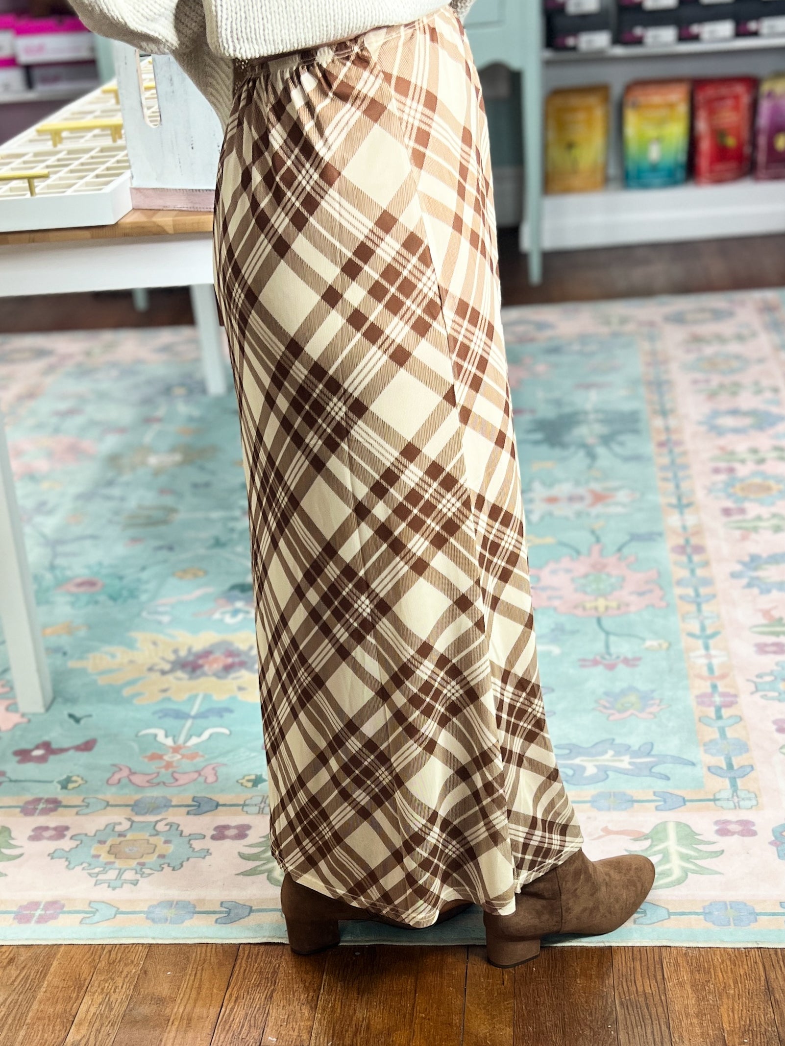Taupe and brown plaid midi skirt with long A-line shape and flared hem