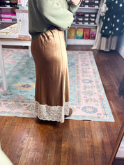 Camel satin midi skirt with scalloped white lace hem detail, front view