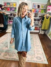 Oversized denim shirt dress with button front and chest pockets, knee length