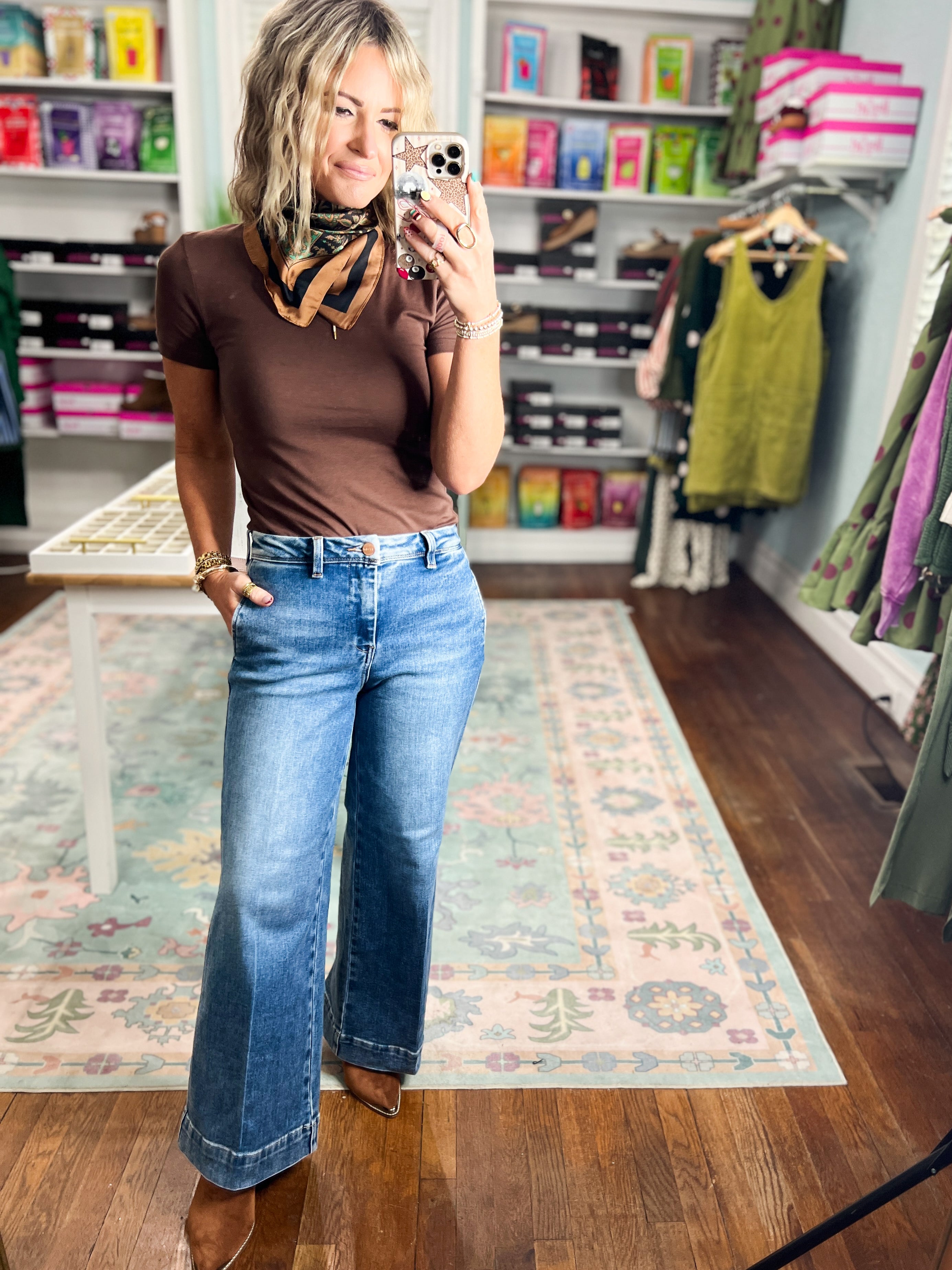 Dark wash wide-leg ankle jeans, relaxed slouchy waist, visible front pockets and long leg