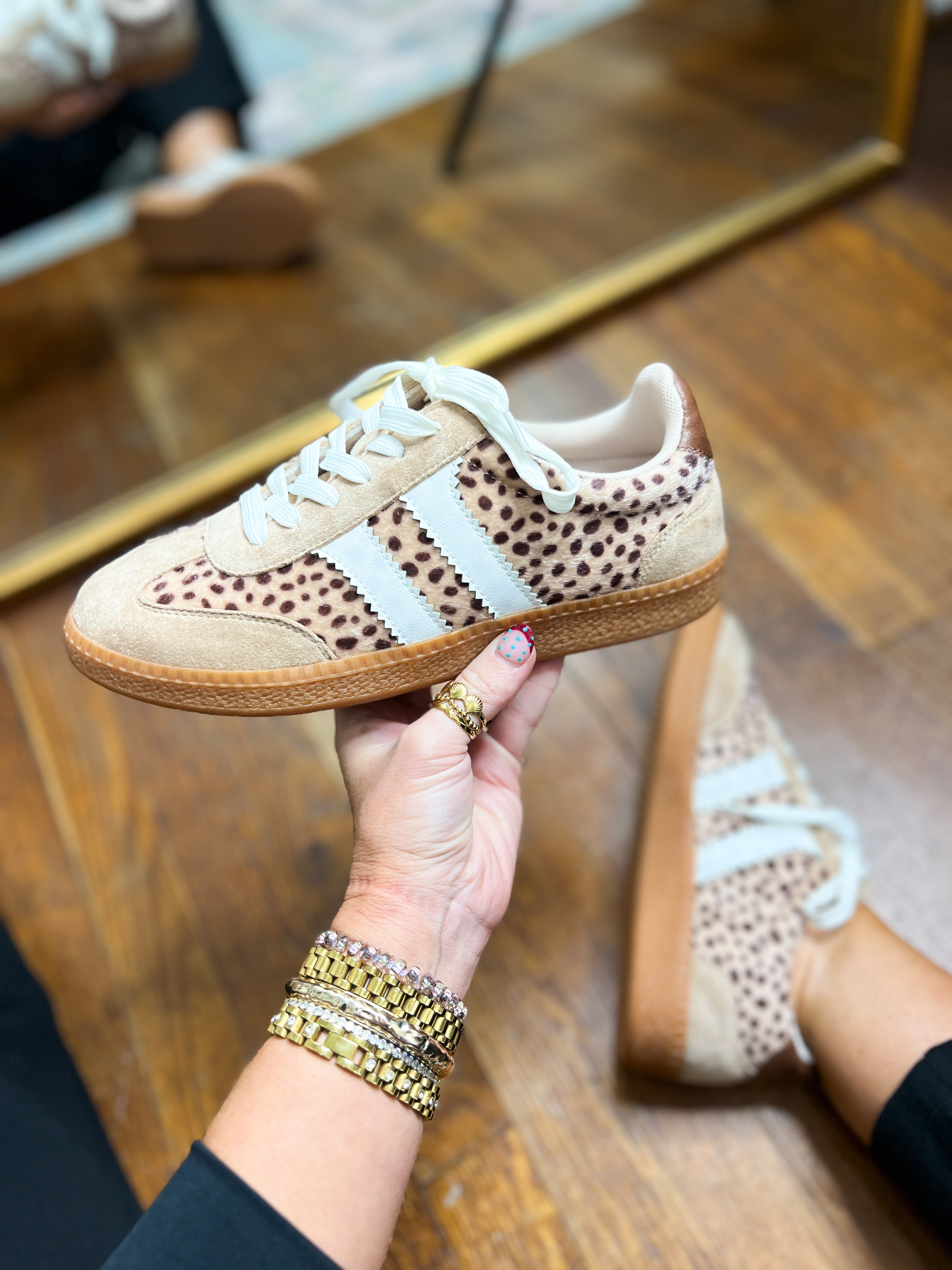 Leopard-print mini sneakers with white laces, tan suede panels, and light rubber sole.