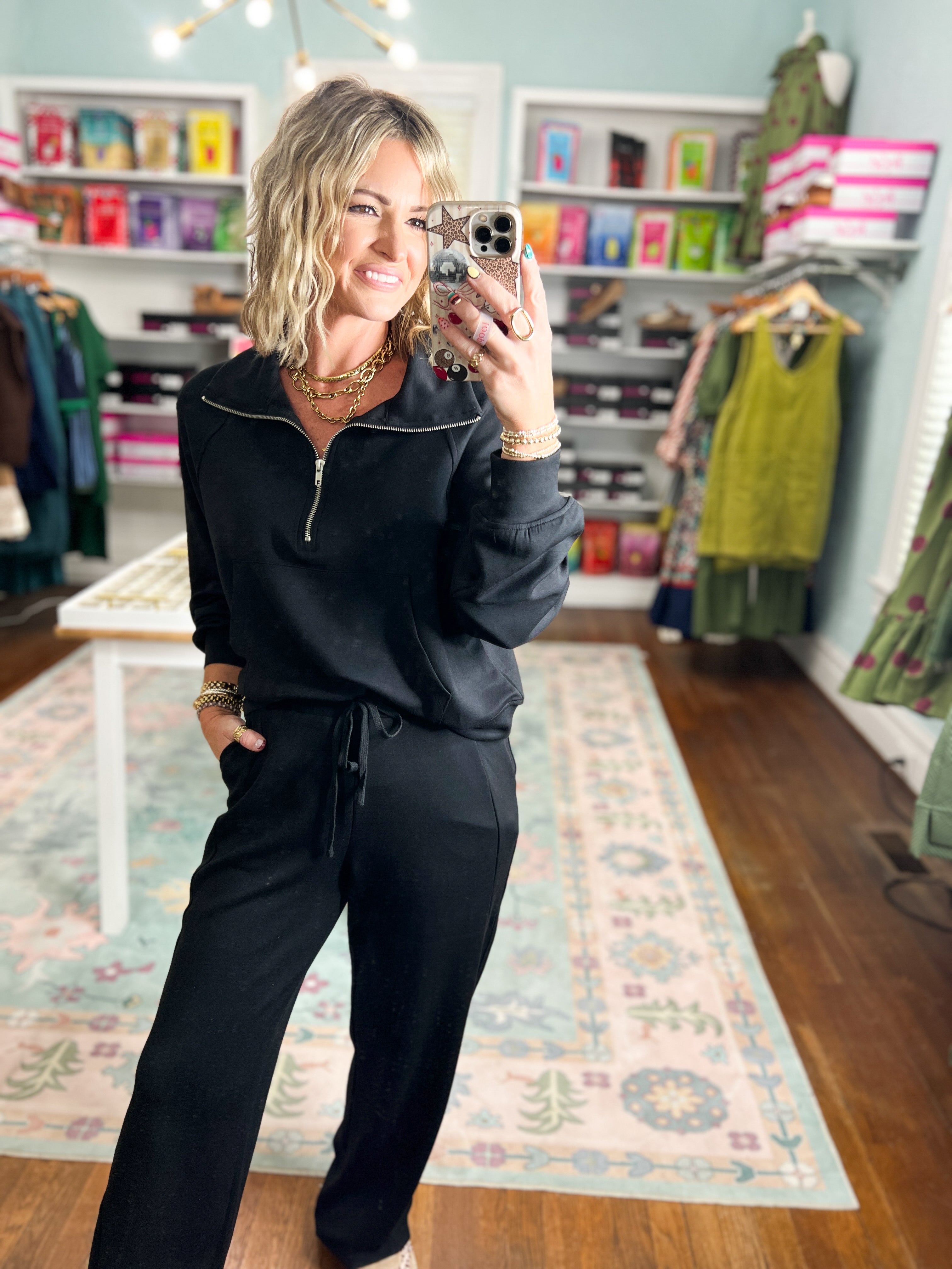 Black half-zip raglan pullover with zip neckline and long sleeves, casual pullover