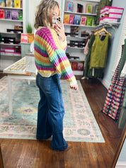 Rainbow striped cardigan side view, button front and long sleeves