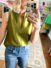 Olive sleeveless satin top close-up with scoop neckline