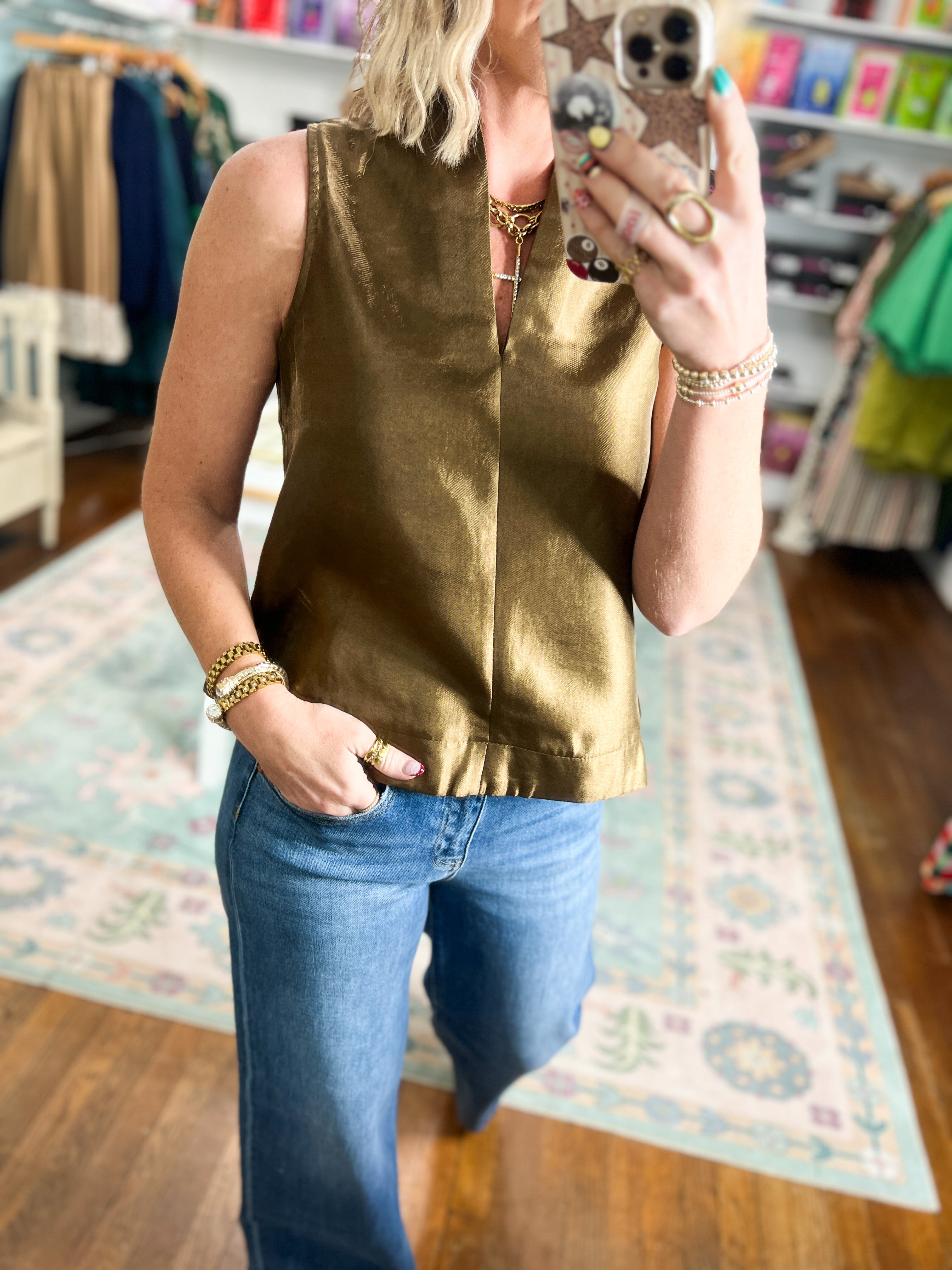 Brown satin sleeveless top with crew neck, center seam, and straight hem