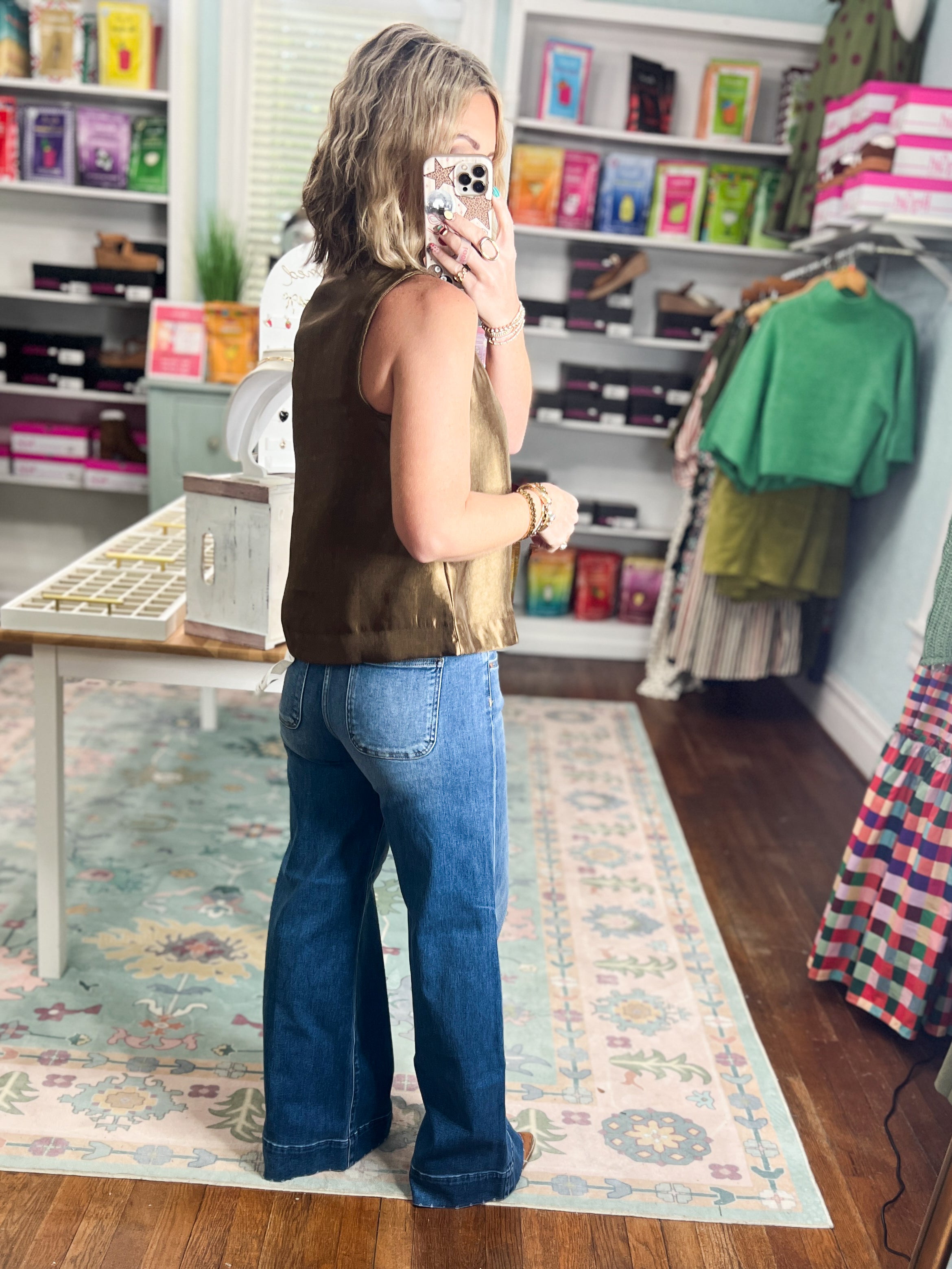 Brown sleeveless satin top with crew neck and front center seam, relaxed fit