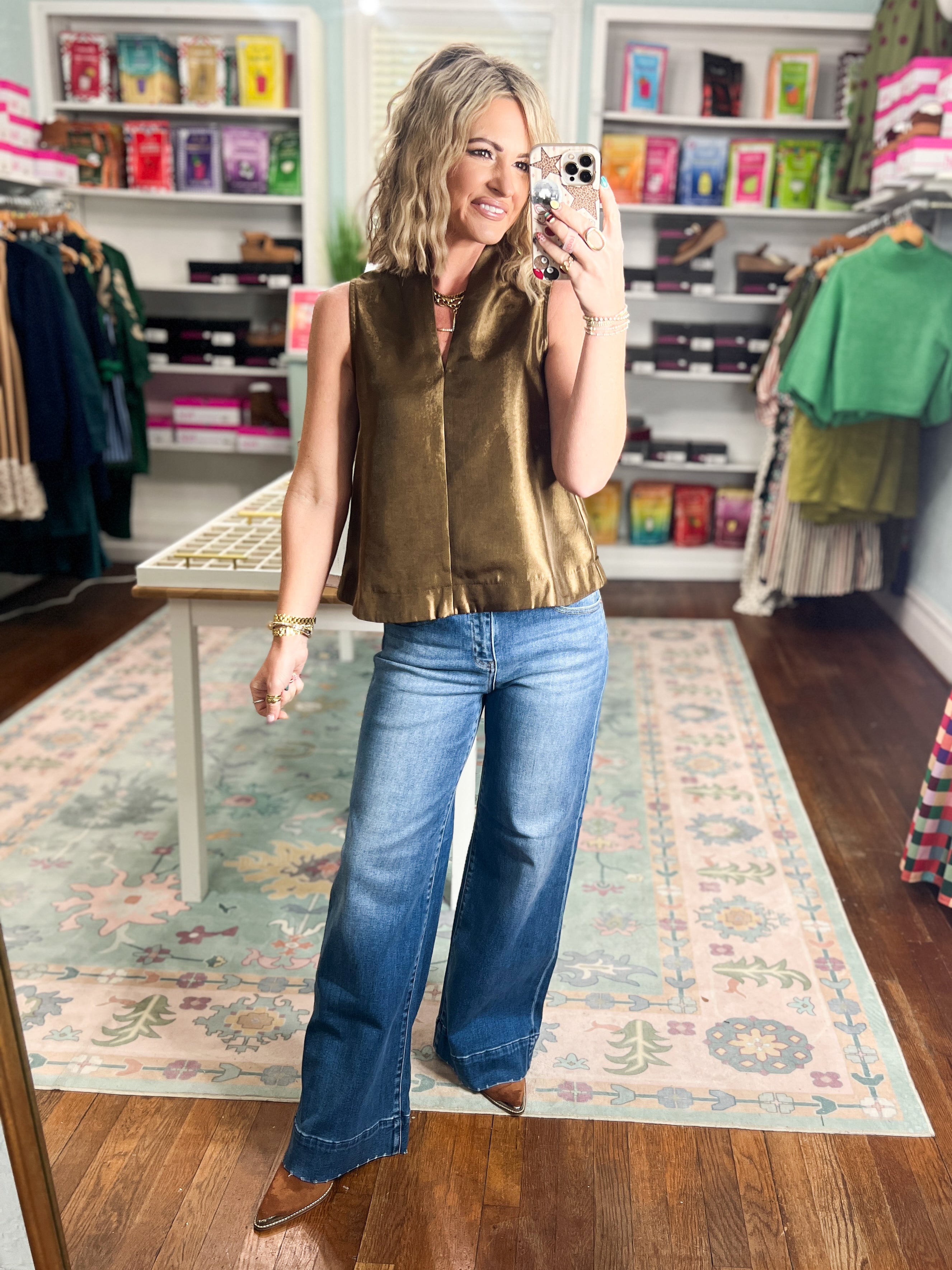 Brown sleeveless satin top with crew neck, center seam, and relaxed silhouette