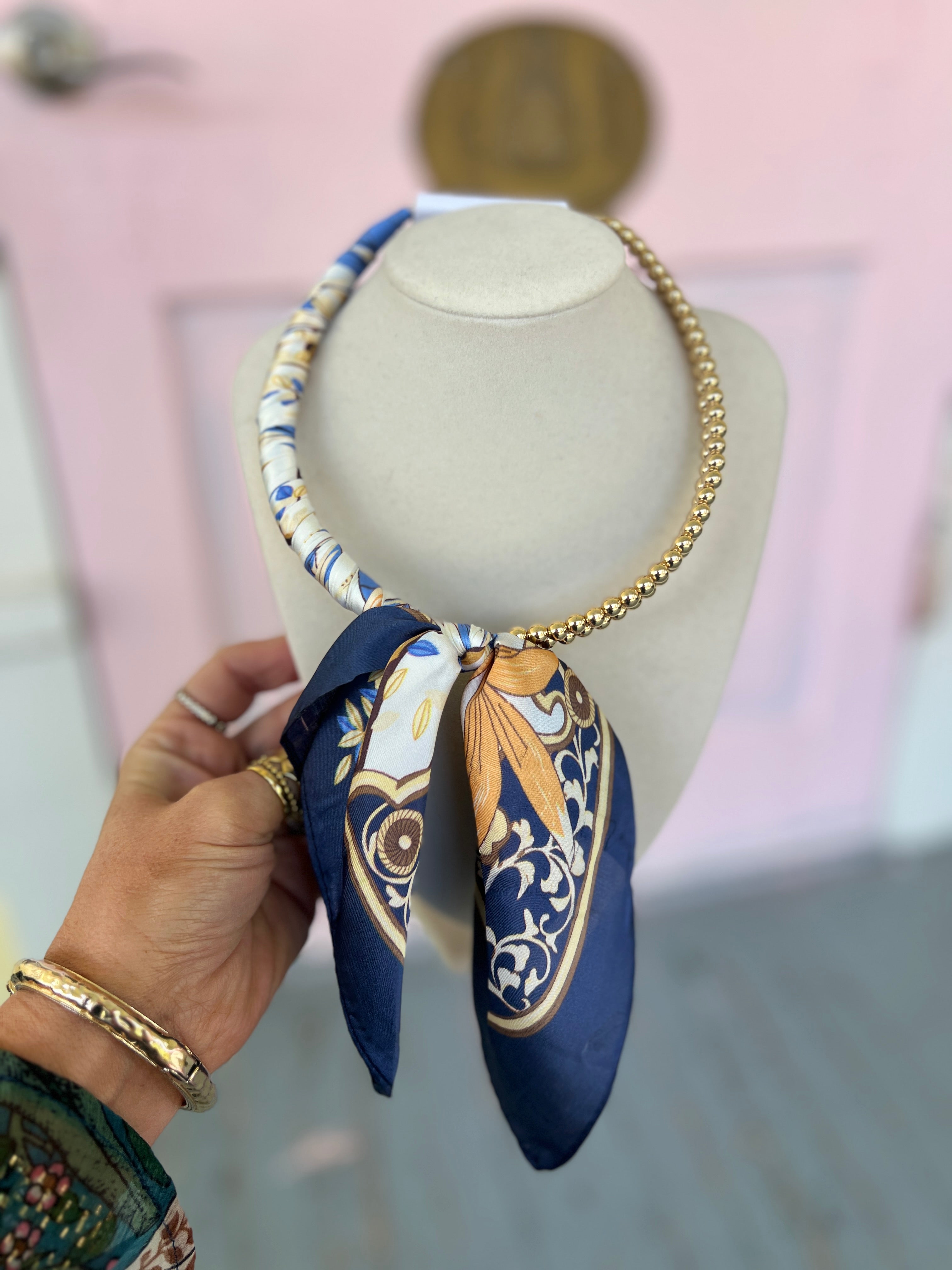 Navy and gold collar necklace with a patterned scarf wrap and gold-tone chain