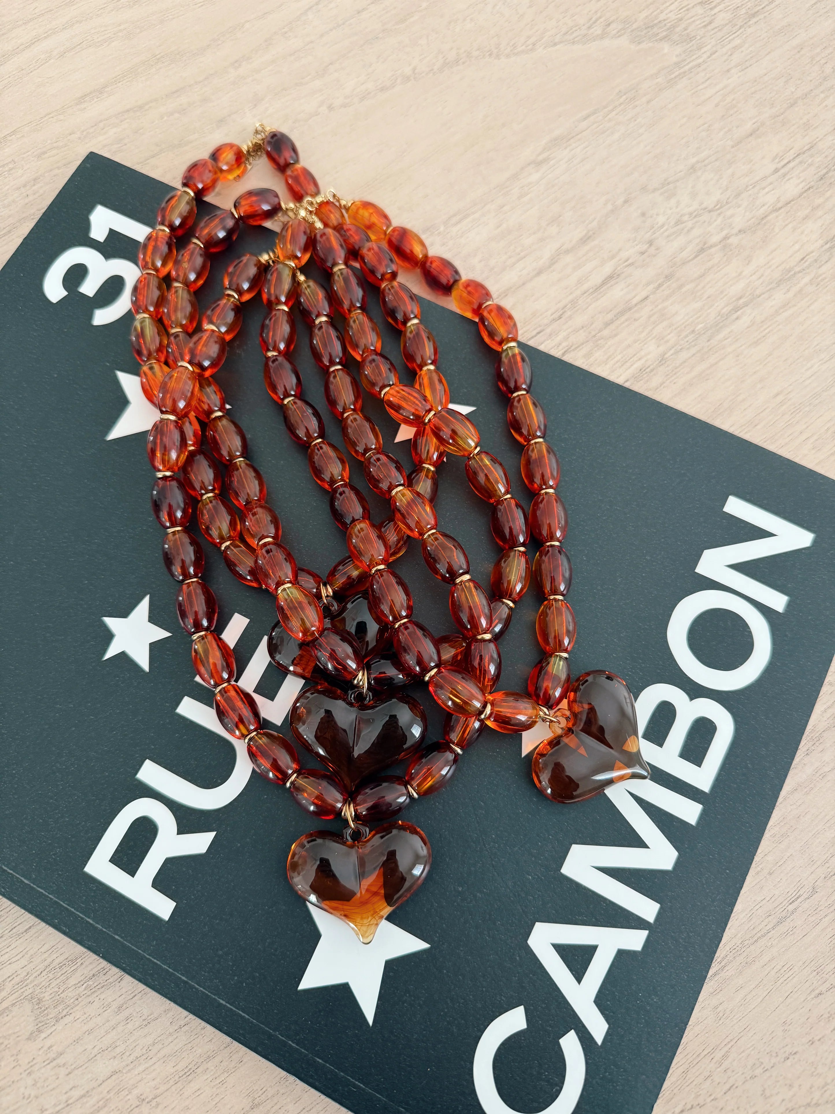 Amber oval bead necklace with stacked heart charms