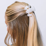 Teleties petite coconut white claw clip holding blonde hair back.