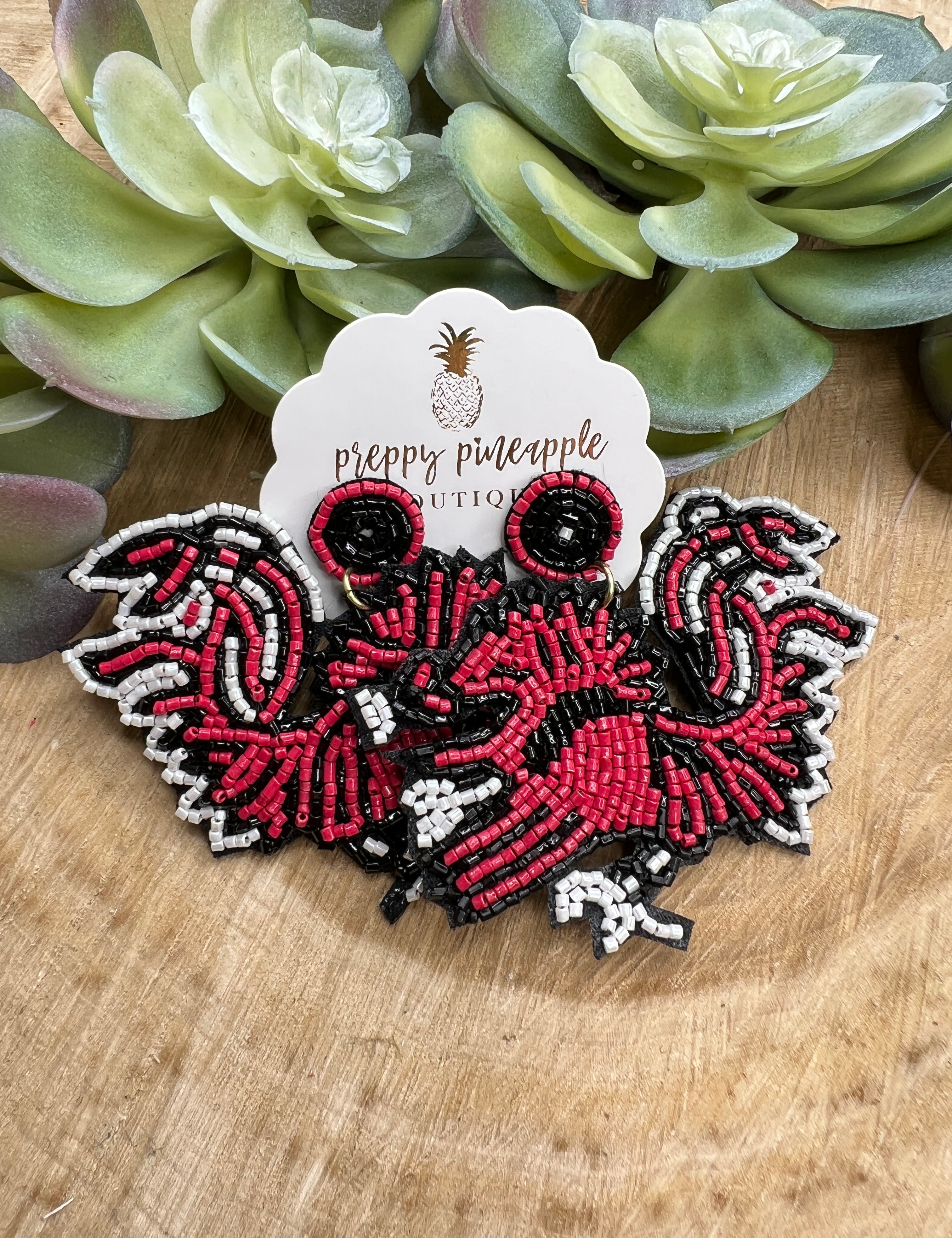 Beaded gamecock earrings with red, black, and white seed beads